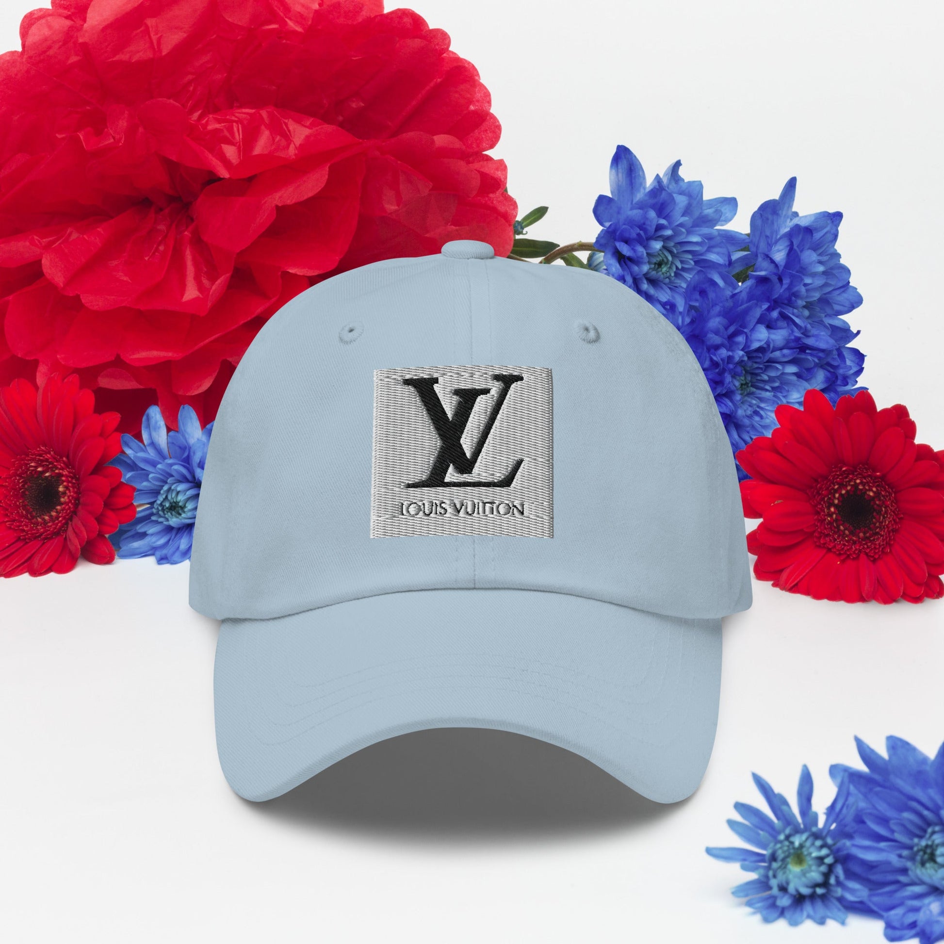 Dad hat with low-profile design, adjustable strap, and curved visor; features unstructured 6-panel construction in blue fabric with floral background.